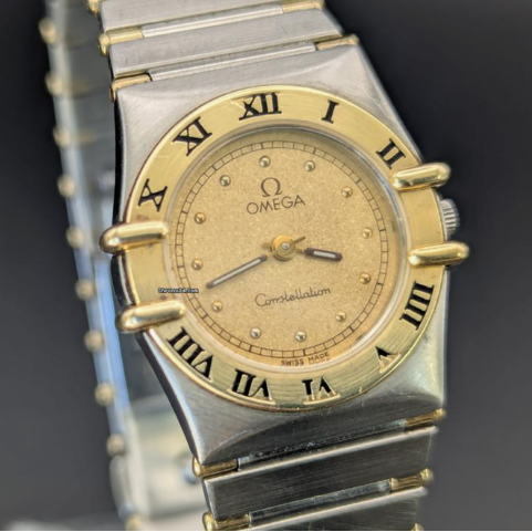 Luxury watch with gold and silver band on a dark background